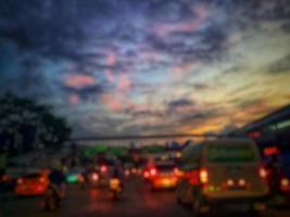 Defocused blurred abstract background of traffic jam at night in east Jakarta. The rear view, the red and yellow lights or the brake lights of the cars are on. photo