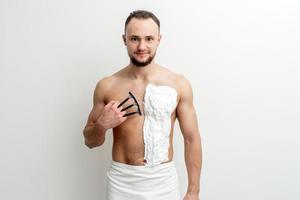 Young man shaving his chest photo