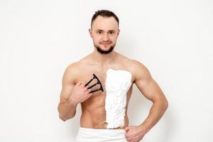 Young man shaving his chest photo