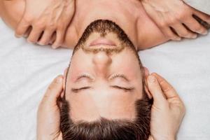 Young man receiving head massage. photo