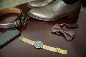 The groom's fees, jacket and watch photo