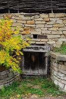 old weathered door in the wooden wall of an ancient hut photo