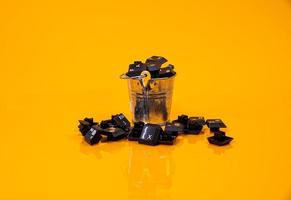 keyboard button in glass in jar in bucket on orange background photo