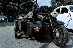 Old Tricar, Three-Wheeled Gray Motorcycle With A Sidecar Of German Forces photo