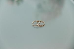 Two wedding rings on the floor with contrast photo