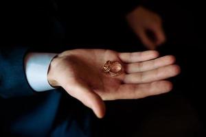 Human hand holding a ring inside on white background photo