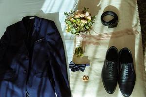 The groom's fees, jacket and watch photo