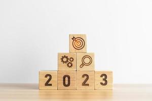 2023 wood block with business goal, plan. Action strategy, target, mission, teamwork, idea and New Year start concept photo