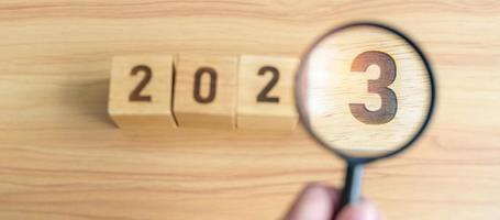 2023 block with magnifying glass. SEO, Search Engine Optimization, hiring , Advertising, Idea, Strategy, marketing, Keyword, Content and New Year start concepts photo