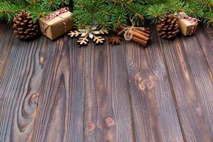 Christmas background with fir tree and gift box on wooden table. Top view with copy space for your design photo