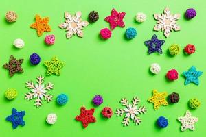 New Year decorations on green background. Festive stars and balls. Merry Christmas concept with empty space for your design photo