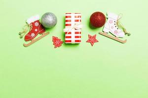 Top view Christmas ball, gift and creative decorations on colorful background. New Year holiday concept with copy space photo