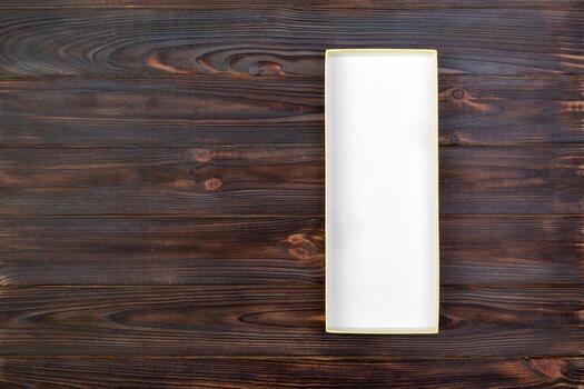 White rectangular empty open box, top view on dark wooden background. top view photo