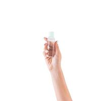 Female hand holding cream bottle of lotion isolated. Girl give tube cosmetic products on white background photo