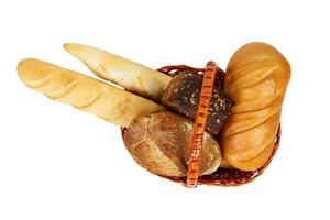 Mixed bread in basket isolated on white background. Top view photo