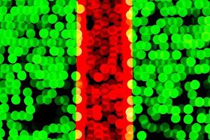 Unfocused abstract green and red bokeh on black background. defocused and blurred many round light photo