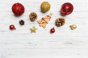 Winter set made of Christmas balls and various decorations on holiday wooden background. Top view of New Year concept with copy space photo