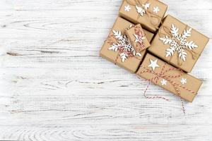 Christmas wooden background with gift boxes and decor. Top view with copy space for your text photo