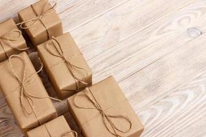 Gift wrapping composition. homemade wrapped present boxes on wooden background. above view copy space photo