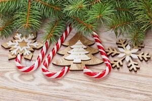 Christmas candy canes and snowflakes on a wooden background photo