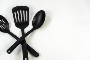 black plastic kitchen utensils isolated on white. Clipping path included. mexico photo