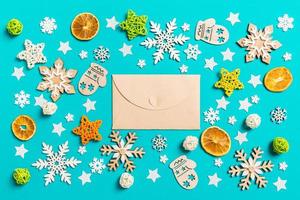 Top view of craft envelope on blue background with New Year toys and decorations. Christmas time concept photo