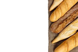 baguette of whole wheat bread on a white background photo