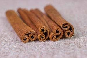 cinnamon sticks on a gray brown linen background photo