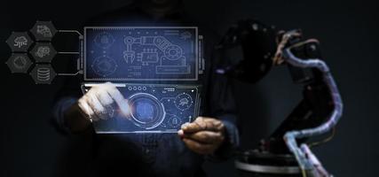 Engineers use their fingers to the displayed image. In order to divide the control of automatic robotic arms in AI technology, AI technology is what is used in the world today and in the future. photo