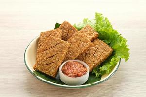 Tempeh, Tempe Goreng or Fried tempeh is Indonesia traditional food, made from fermented soybean seeds. Served with sambal. photo