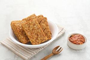 Tempeh, Tempe Goreng or Fried tempeh is Indonesia traditional food, made from fermented soybean seeds. Served with sambal. photo