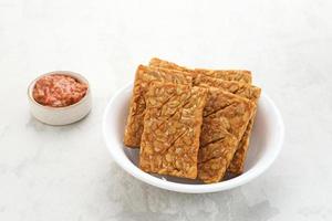 Tempeh, Tempe Goreng or Fried tempeh is Indonesia traditional food, made from fermented soybean seeds. Served with sambal. photo