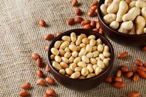 Peanuts in the shell and peeled closeup in a cup photo