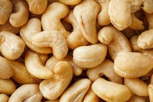 Cashew with no shell on a background. Macro nuts, Organic vegan food. photo