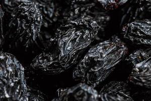 Black Raisin texture, popular dried fruit. Dried grapes. photo