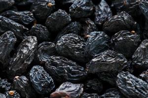 Black Raisin texture, popular dried fruit. Dried grapes. photo