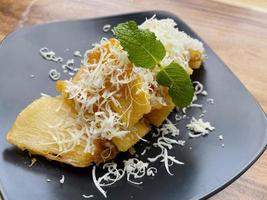 fried cassava with topping grated cheese on top photo