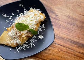 fried cassava with topping grated cheese on top photo