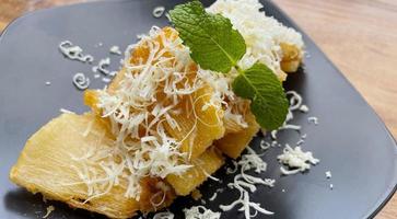 fried cassava with topping grated cheese on top photo