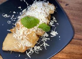 fried cassava with topping grated cheese on top photo