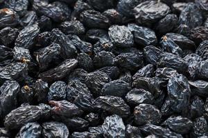 Black Raisin texture, popular dried fruit. Dried grapes. photo