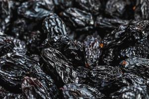 Black Raisin texture, popular dried fruit. Dried grapes. photo