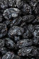 Black Raisin texture, popular dried fruit. Dried grapes. photo