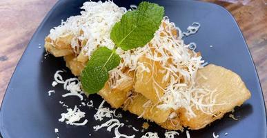fried cassava with topping grated cheese on top photo