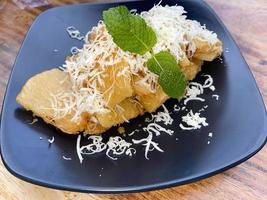fried cassava with topping grated cheese on top photo
