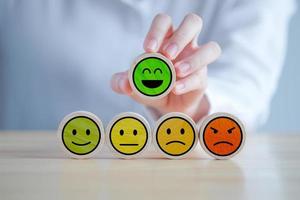 Feedback rating and positive service review. Customer experience, Mental health assessment, World mental health day, think positive, Emotion, satisfaction survey. Hand choosing happy smiling face. photo