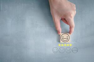 Feedback rating and positive service review. Customer experience, Think positive, Emotion, World mental health day, Mental health assessment, satisfaction survey. Hand choosing happy face with 5 star. photo