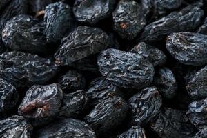 Black Raisin texture, popular dried fruit. Dried grapes. photo