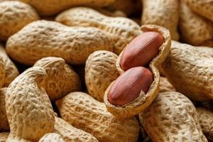 Peeled peanut on well peanuts. Peanuts, for background or textures. photo