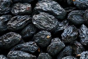 Black Raisin texture, popular dried fruit. Dried grapes. photo